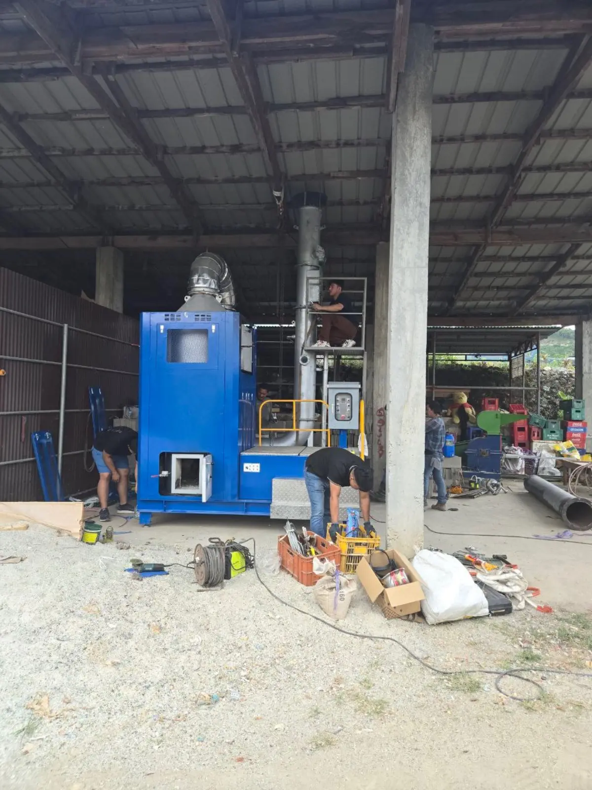 GEGT team installing a GREENASH 5 under an open shed